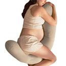 Pregnant person comfortably hugging a Frida Mom Compact Support 4-in-1 Cooling Pregnancy Pillow while lying down.
