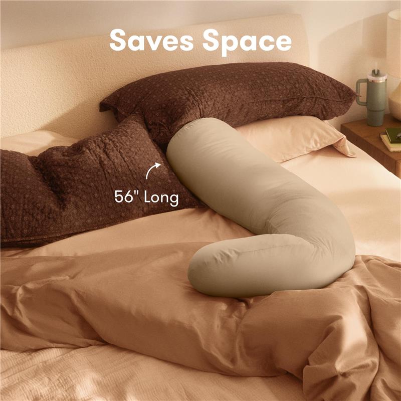 4-in-1 cooling pregnancy pillow in a beige color, measuring 56 inches long, on a bed with brown and beige bedding.