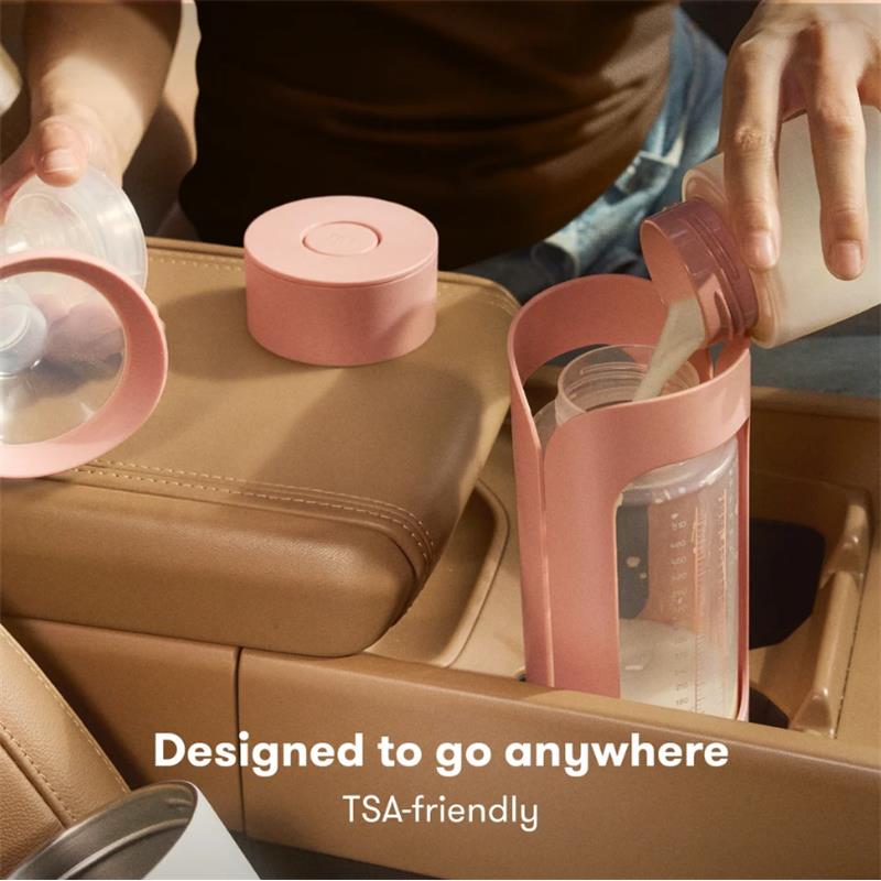 Frida Mom Flow + Go Breastmilk Cooler on a car console, featuring pink storage container and bottle being filled with milk.