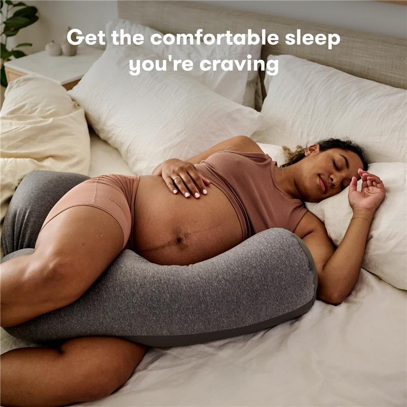 Gray Frida Mom Pregnancy Body Pillow supports a pregnant woman sleeping comfortably in bed, highlighted by promotional text.