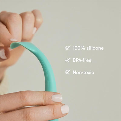 Diaper Cream Booty Brush displayed being held, made of 100% silicone, labeled as BPA-free and non-toxic.