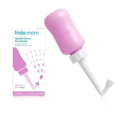 Frida Mom Upside Down Peri Bottle in pink, designed for postpartum care, alongside its packaging showing usage instructions.