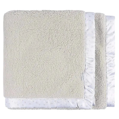 Plush beige blanket with a soft texture and a satin celestial-themed border, featuring moons and stars.