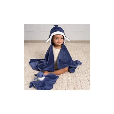 Child wearing a whale-themed hooded blanket set, featuring a blue blanket and a matching small blanket.