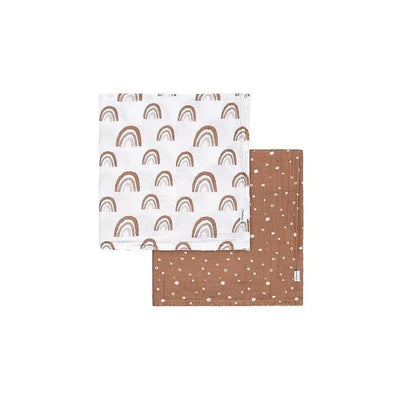 Muslin blanket set featuring a white blanket with brown boho rainbows and a brown blanket with pastel polka dots.