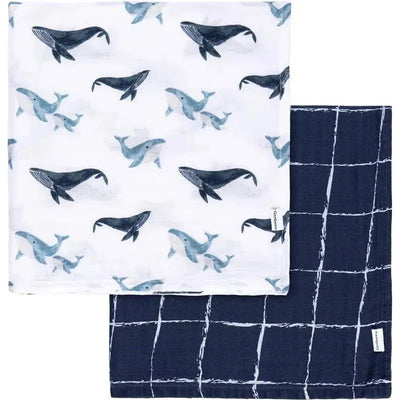 Two muslin blankets from Gerber, one with whale patterns and the other in a navy grid design.