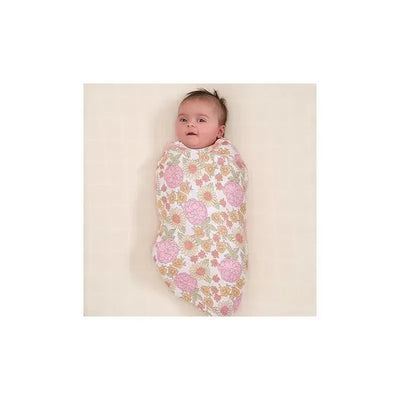 Baby wrapped in a Gerber muslin blanket featuring a retro floral pattern in pink and yellow.