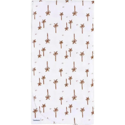 Flannel blanket featuring a dino-themed design with palm trees on a white background. Part of the Gerber Bedding 4-pack.