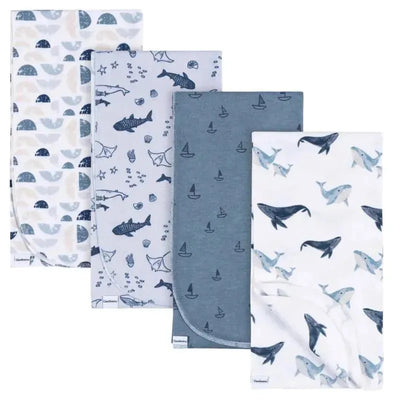 Four flannel blankets featuring whale and ocean-themed designs in blue and white colors.