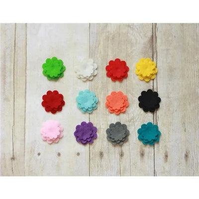 Assorted felt flower accessories in a 3-pack, featuring various colors including red, pink, yellow, and green.
