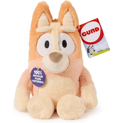 Bingo plush toy with orange and cream fur, large eyes, and a tag indicating 100% recycled materials.