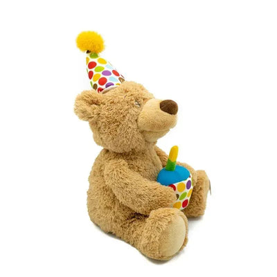 Gund Happy Birthday plush bear wearing a colorful party hat and holding a birthday cake with candles.