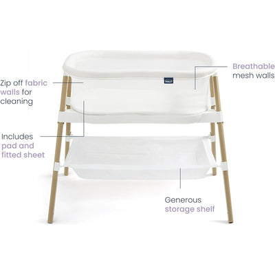 HALO BassiNest Essential Sleeper in white with zip-off fabric walls, breathable mesh sides, included padded sheet, and storage shelf.