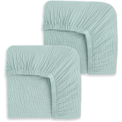 Fitted crib sheets set of two in a calm sage color, showcasing soft, textured fabric and elastic edges for secure fit.