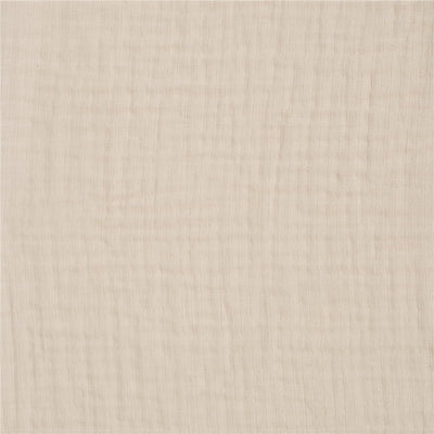 Full-sized fitted crib sheet in soft oat color, featuring a textured, breathable fabric suitable for infants.