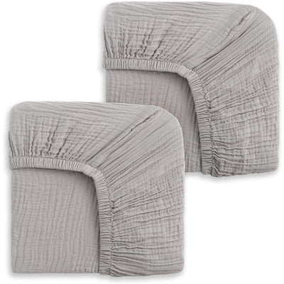 Two storm grey fitted crib sheets, showcasing a soft, textured fabric with elastic edges for secure fit.