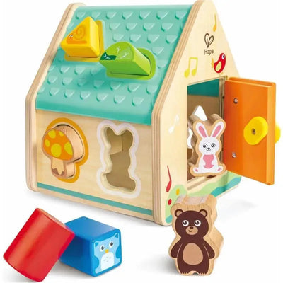 Wooden shape sorter house with colorful animal blocks, including a bunny, bear, and owl, featuring multiple shapes on top.