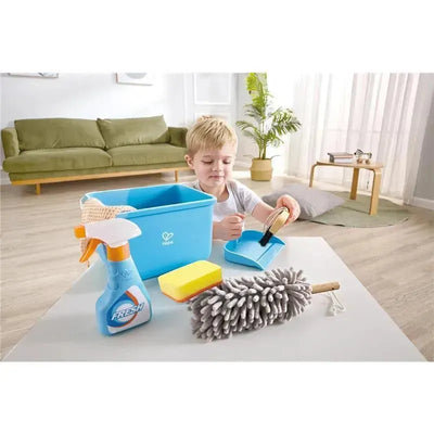 Child playing with the Hape Kids Toy Cleaning Game, using a brush and cleaning supplies like a spray bottle and sponge.