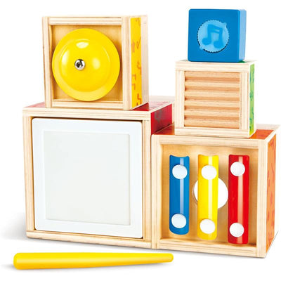 Colorful wooden blocks from the Hape Stacking Music Set, featuring a yellow bell, musical notes, and a yellow stick.