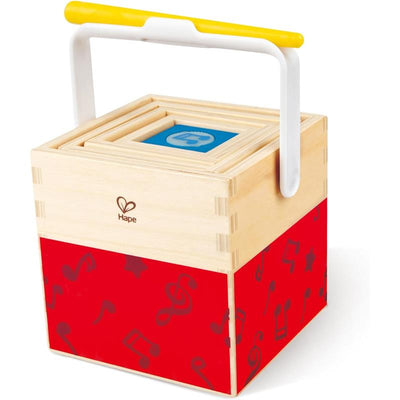 Hape Stacking Music Set featuring a wooden cube with a yellow handle and a red base decorated with music notes.