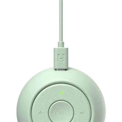 Mint-colored Hatch Rest Go portable sound machine with a power cord and control buttons for volume and sound selection.