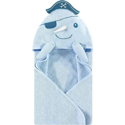Hooded towel designed for babies, featuring a narwhal face with a pirate hat and an eye patch, in soft blue cotton.