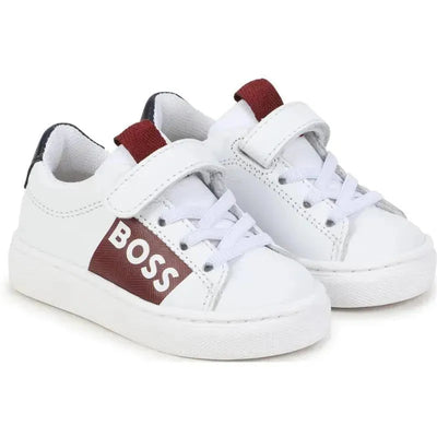 White Hugo Boss Baby sneakers featuring a burgundy strap and logo, designed for boys, with Velcro and lace closure.