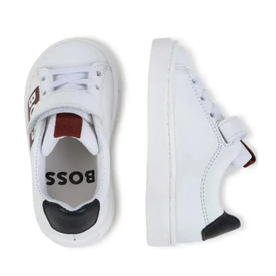 White Hugo Boss Baby boy sneakers with Velcro strap and red and black accents, viewed from the top and side.