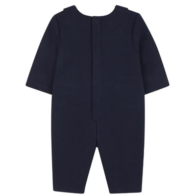 Navy blue suit-style romper for boys with short sleeves and a back closure.