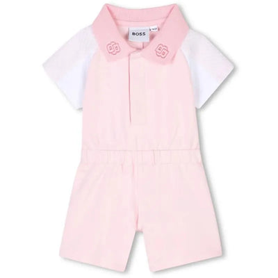 Pale pink all-in-one romper for girls by Hugo Boss, featuring a white short-sleeved top and a collar with logo details.