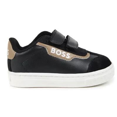 Black leather and mesh Hugo Boss baby sneakers feature velcro straps and white soles, highlighted with a tan logo.