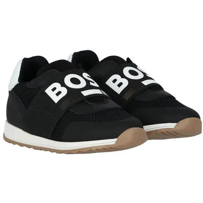 Black and white Hugo Boss baby sneakers made of leather and mesh, featuring logo elastic straps and a brown sole.