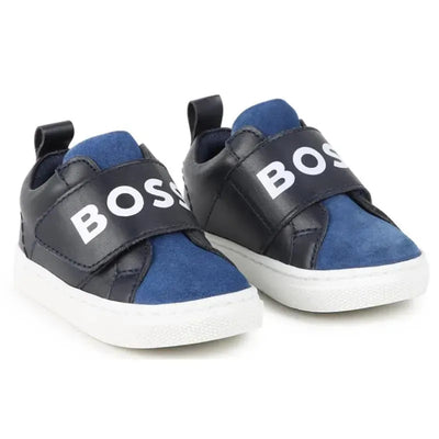Navy Hugo Boss sneakers featuring an elastic logo strap and a mix of suede and leather textures.