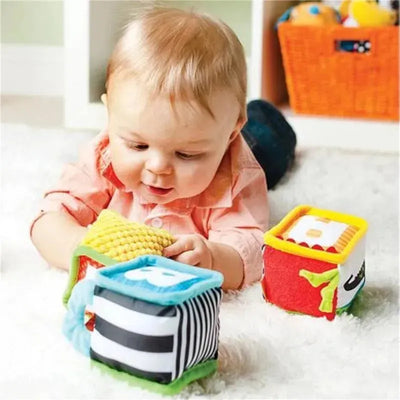 Infantino Discover & Play Soft Blocks with a baby exploring colorful, textured blocks on a soft surface.