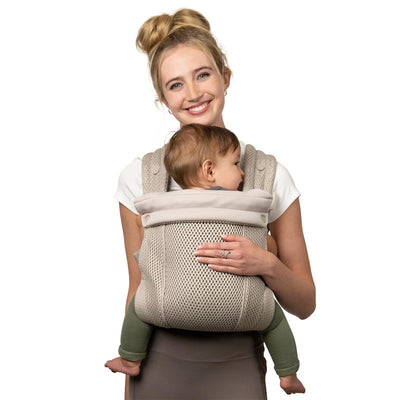 Infantino Honey Blossom Airy Baby Carrier in Moon Beam, featuring a smiling caregiver holding a child securely.