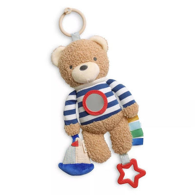 Brown plush bear toy wearing a striped shirt, featuring a mirror, a sailboat, colorful tags, and a hanging ring.
