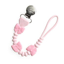 Pink silicone pacifier clip with bow-shaped beads and metal clip for securely attaching pacifiers.