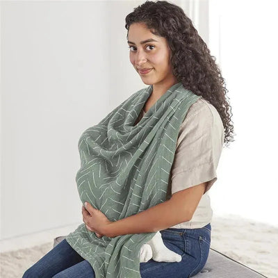 Breastfeeding Boss Multi-Use Cover in sage color, draped over a mother, offering privacy while nursing.