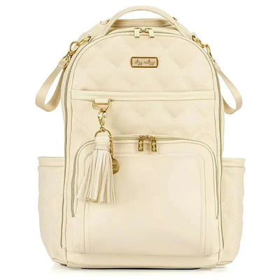 Large capacity Itzy Ritzy diaper bag backpack in cream with gold accents, featuring quilted design and front pockets.