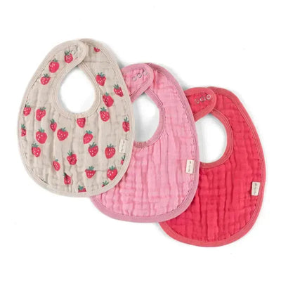 Three Itzy Ritzy baby bibs in shades of pink, including one with a strawberry print, designed for mealtime use.