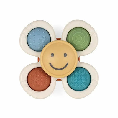 Itzy Ritzy Itzy Pop & Whirl sensory toy featuring a smiling face and textured petals in various colors for tactile play.