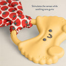 Pasta-shaped silicone teether with a crinkle tie, featuring a happy face and tomato-patterned fabric, soothes sore gums.