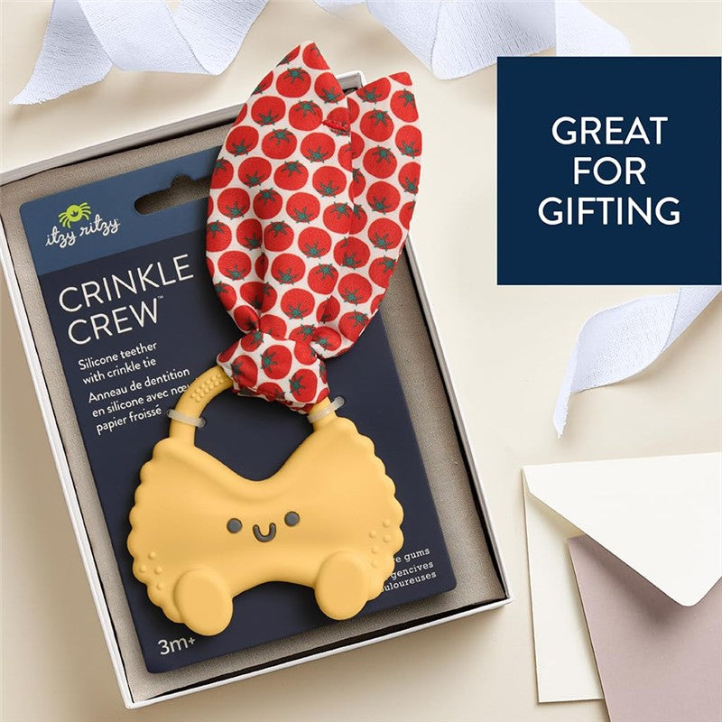 Silicone teether shaped like a smiling pasta with a red tomato-patterned crinkle tie, packaged for gifting.