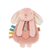 Soft pink bunny lovey with textured teether, featuring colorful ribbon tags and a cozy plush design.