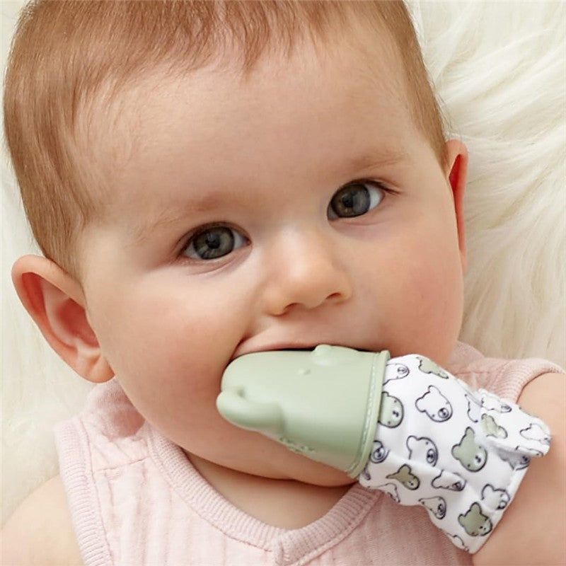 Sage Bear teething mitt worn by a baby, featuring a green silicone bear head and a soft fabric with bear patterns.