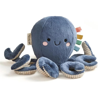Soft blue octopus plush toy with a smiling face and colorful tags on top, surrounded by curly tentacles.