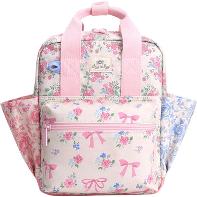 Toddler backpack featuring a floral design with ribbons and roses, pink straps, and a front zippered pocket.