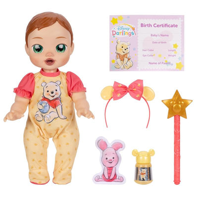 Pooh-inspired 13-inch interactive baby doll with accessories, including a birth certificate, bow headband, and toy figures.
