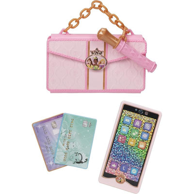 Pink purse toy with a chain handle, adorned with a princess emblem, alongside a toy smartphone and two pretend credit cards.