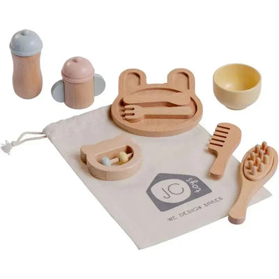 10-piece wooden baby care set including a plate, cutlery, combs, cups, and a pouch, designed for imaginative play.